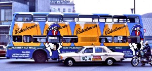 Advertising_on_side_of_Berlin_bus_and_taxi_1977